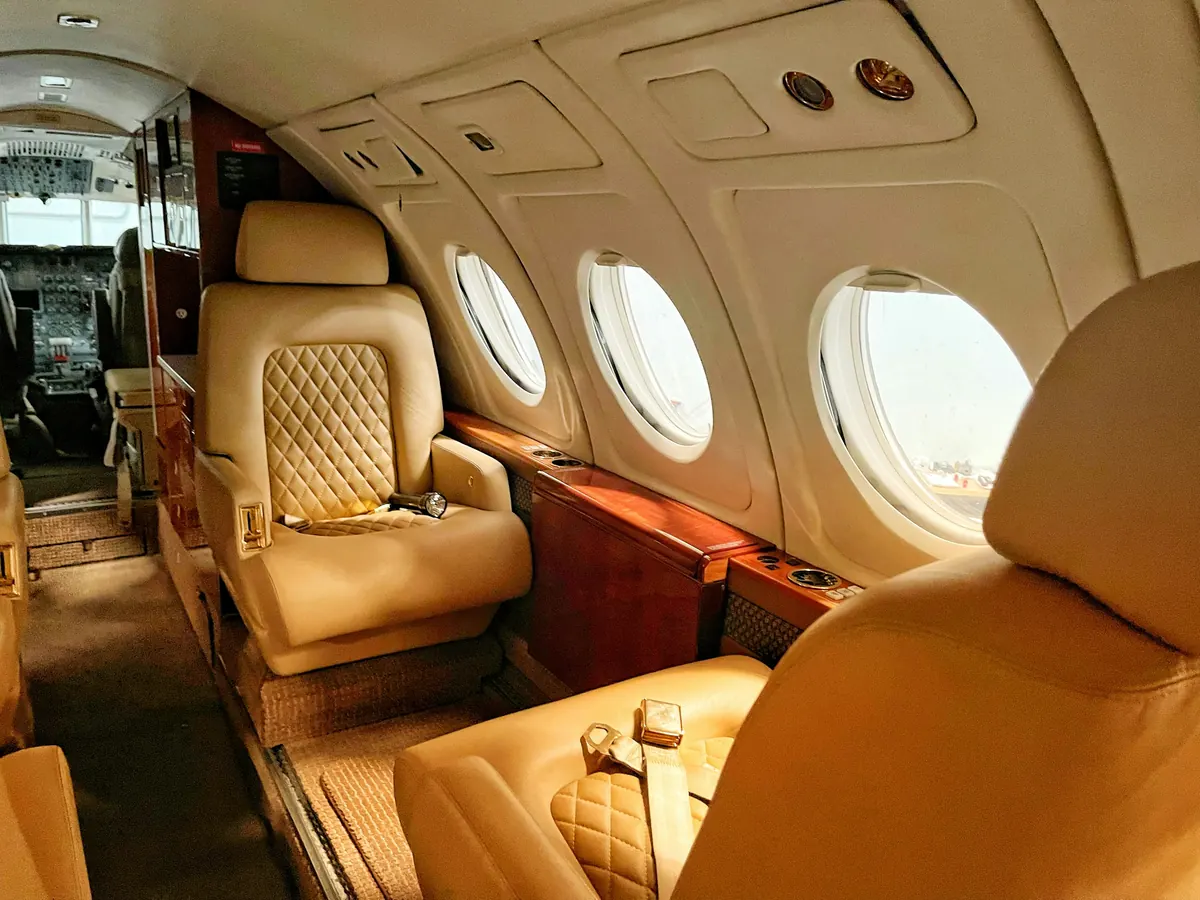 Quilted leather seats in a warmly lit jet cabin