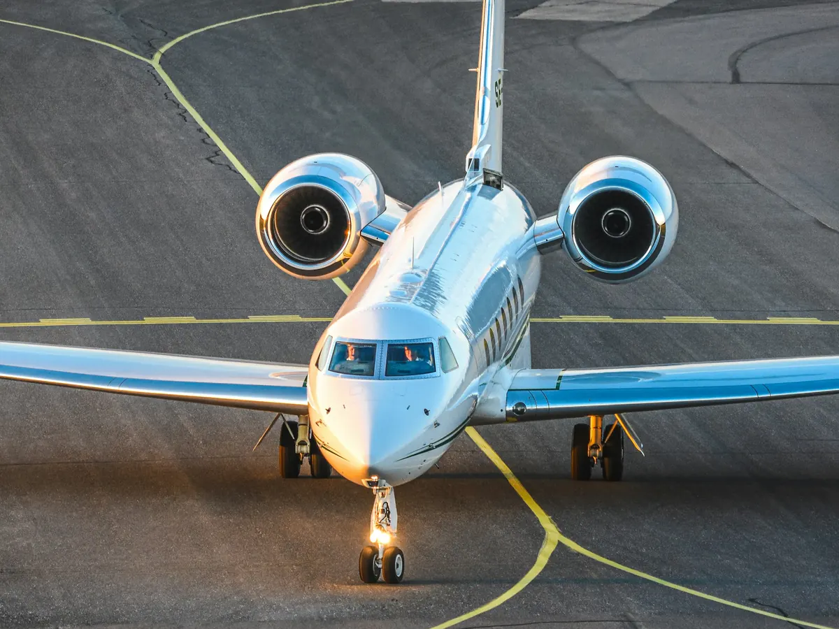 Large-cabin jet taxiing toward the camera
