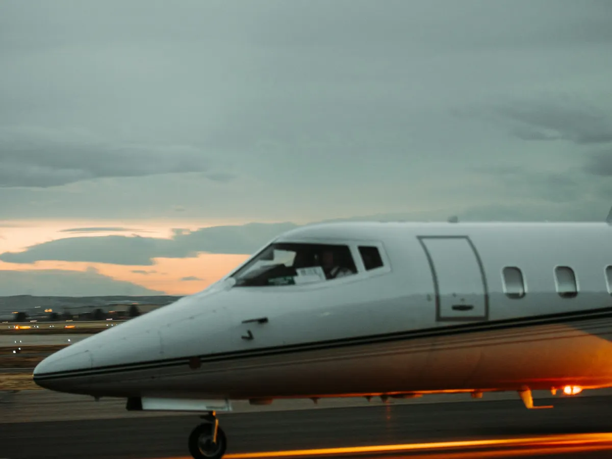 Light jet parked on the ramp under a grey sky