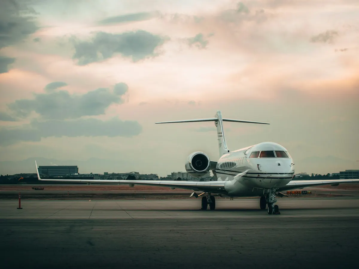 Business jet waiting on the ramp at dusk