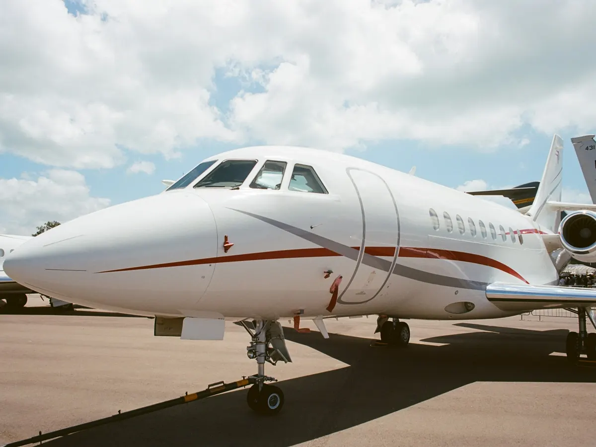 Nose of a Falcon business jet on the apron