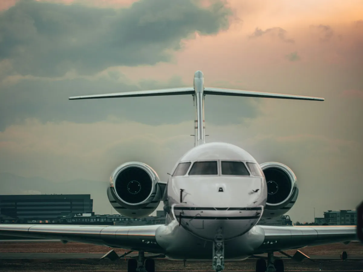 Compact business jet facing the camera at dusk