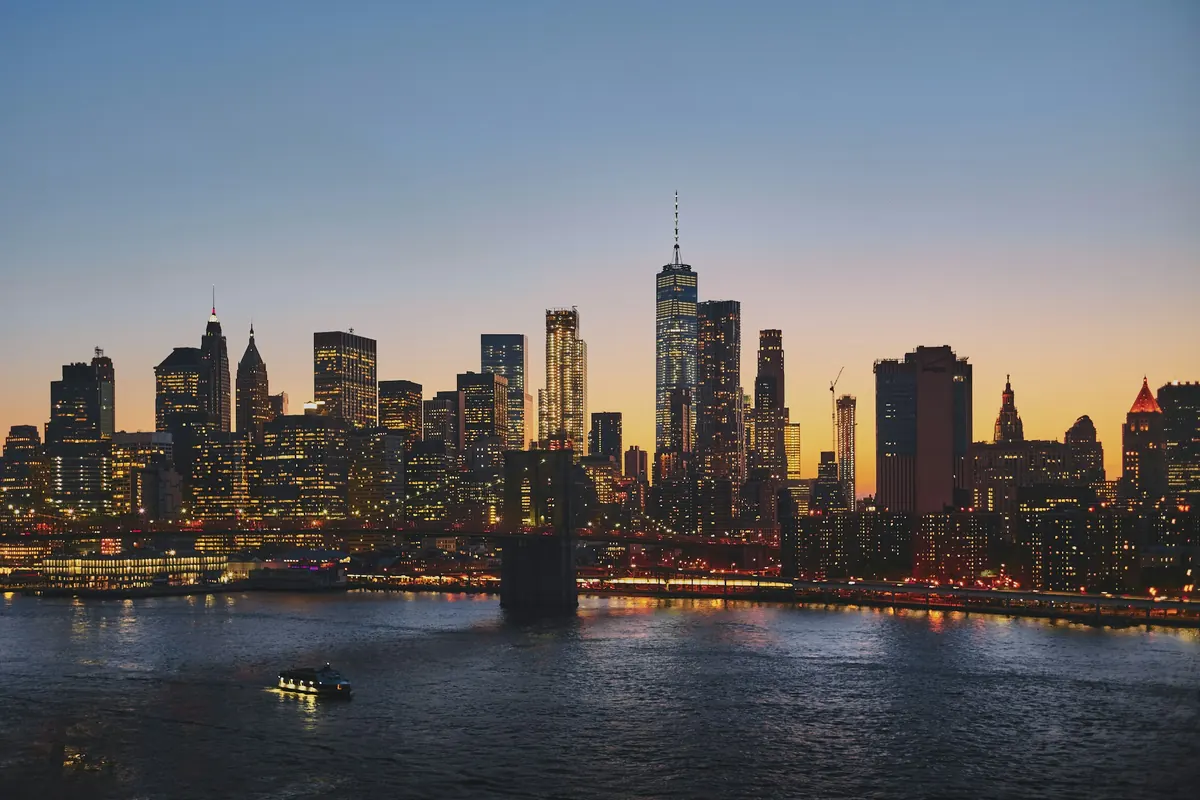 Lower Manhattan skyline across the river at dusk
